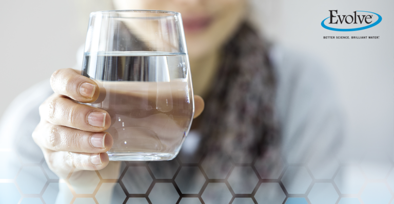 Woman holding a glass of crystal clear water