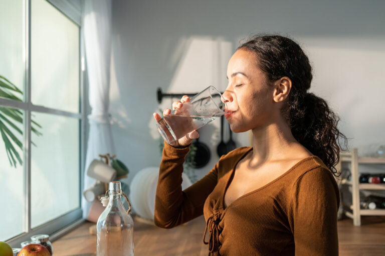 Person drinking water from glass