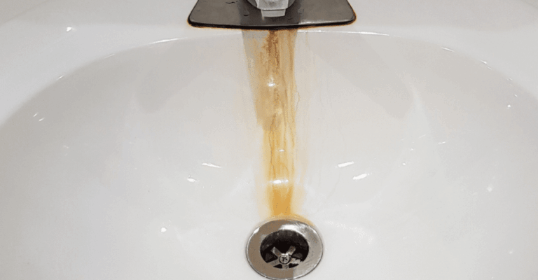 Iron staining in a sink under a faucet from high iron content in water.