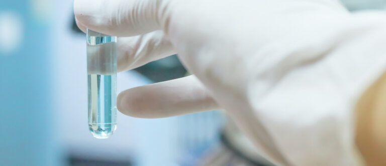 Close-up of glass tube with blue fluid in